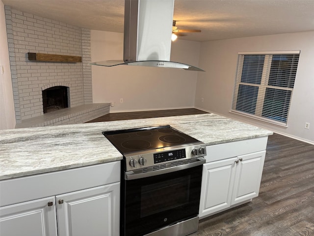 kitchen featuring ceiling fan, island exhaust hood, stainless steel range with electric stovetop, and dark wood finished floors