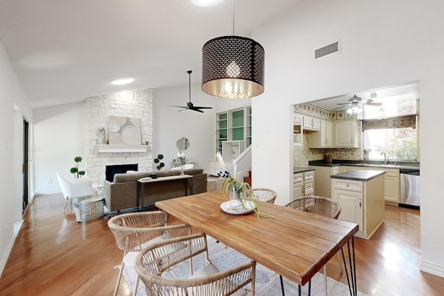 dining area with visible vents, ceiling fan, and light wood finished floors