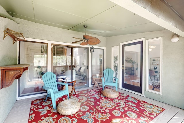 sunroom with a ceiling fan