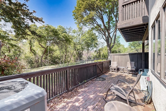deck with a patio, a fenced backyard, and central AC