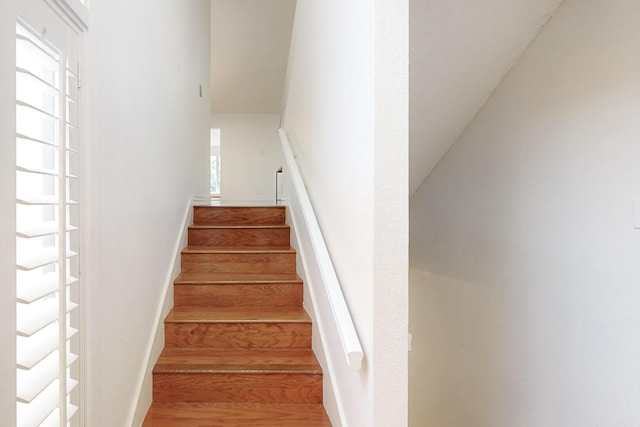 staircase with wood finished floors