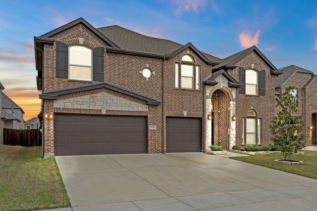 1136 Chickadee Dr, Forney, TX 75126 - french country home featuring an attached garage, brick siding, driveway, and a shingled roof