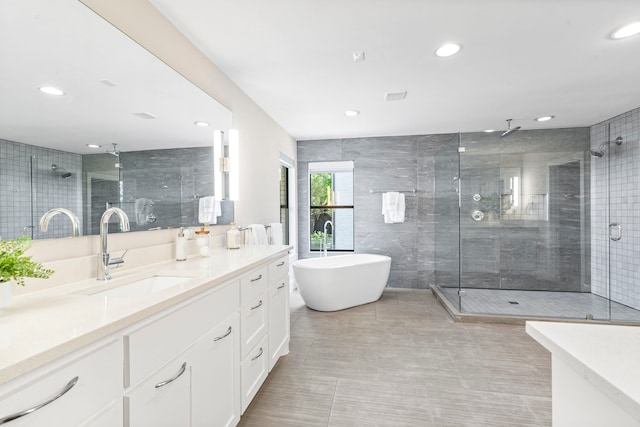 5948 Melshire Dr, Dallas, TX 75230 - full bathroom with vanity, a stall shower, a freestanding tub, recessed lighting, and tile walls