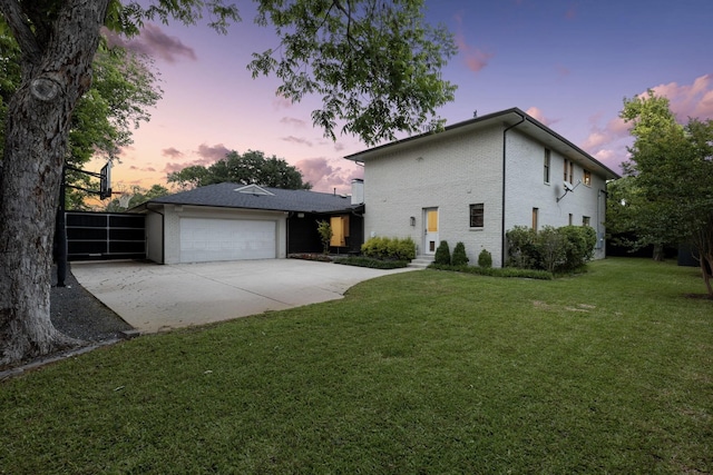 5948 Melshire Dr, Dallas, TX 75230 - view of front of property with concrete driveway, an attached garage, a front lawn, and brick siding