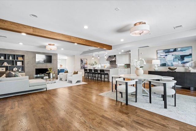 5948 Melshire Dr, Dallas, TX 75230 - dining room with recessed lighting, beam ceiling, wood finished floors, and a fireplace
