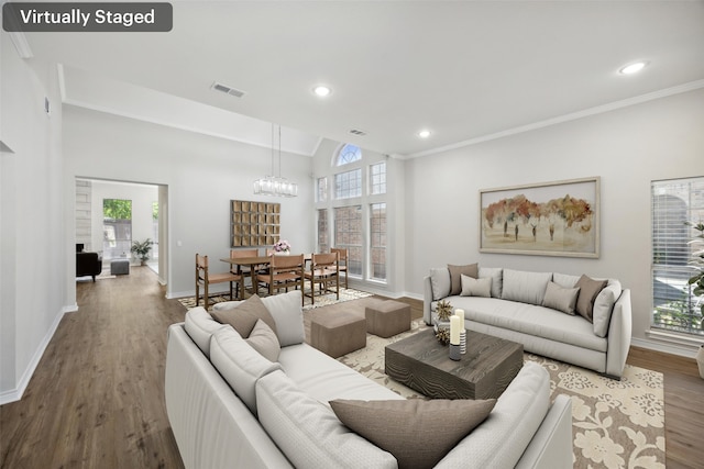 5905 Summer Point Dr, Mckinney, TX 75072 - living room featuring a notable chandelier, visible vents, baseboards, and wood finished floors
