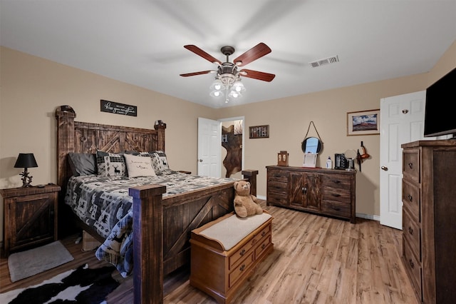 bedroom featuring visible vents, baseboards, light wood-type flooring, and a ceiling fan