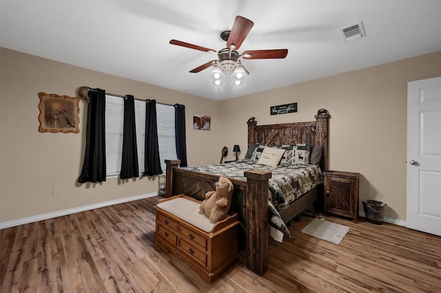bedroom featuring visible vents, baseboards, light wood-type flooring, and ceiling fan