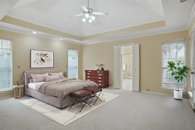 bedroom with light carpet, multiple windows, crown molding, and a raised ceiling