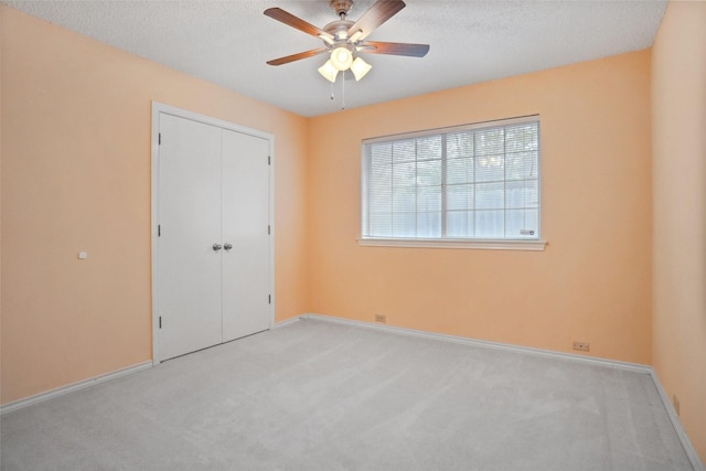 unfurnished bedroom featuring light carpet and baseboards