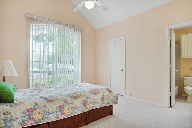 bedroom featuring baseboards, carpet flooring, ensuite bathroom, a ceiling fan, and lofted ceiling