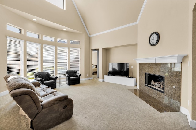 carpeted living area featuring high vaulted ceiling, baseboards, a tiled fireplace, crown molding, and plenty of natural light
