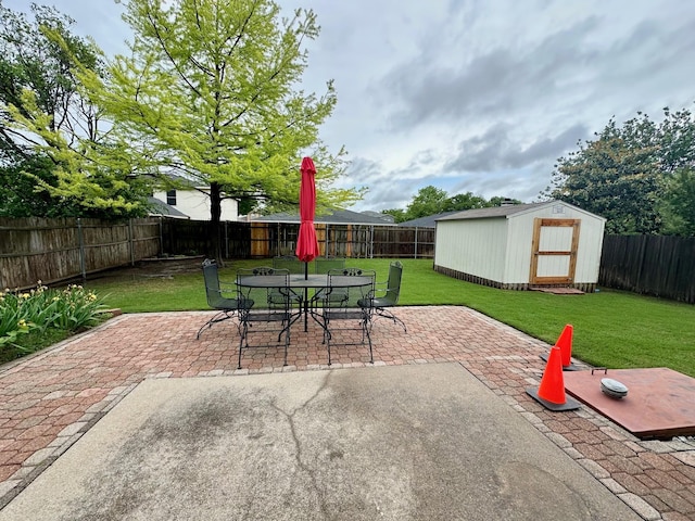 view of patio / terrace with outdoor dining area, a storage unit, and an outbuilding