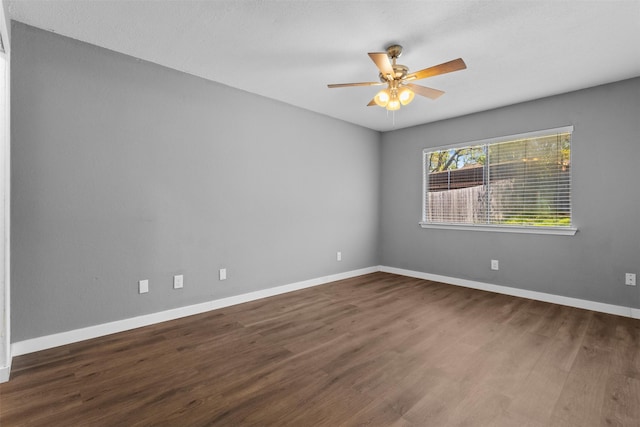 spare room featuring baseboards, a ceiling fan, and wood finished floors