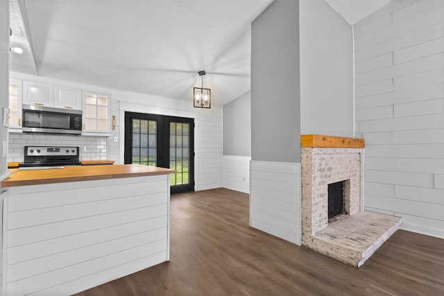 kitchen featuring stainless steel appliances, french doors, white cabinetry, glass insert cabinets, and dark wood-type flooring