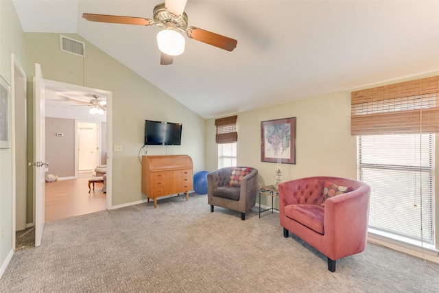 sitting room featuring ceiling fan, carpet, vaulted ceiling, visible vents, and baseboards