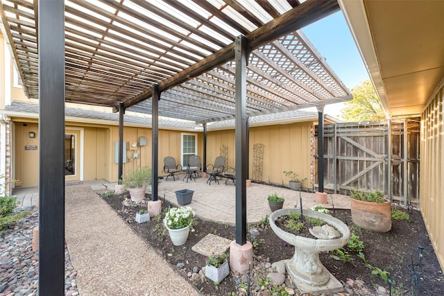 view of patio with a pergola, fence, and a gate
