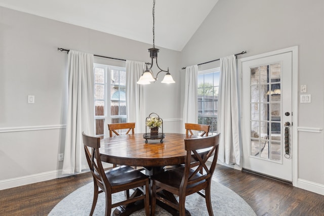 dining space with dark wood-style flooring, baseboards, and vaulted ceiling