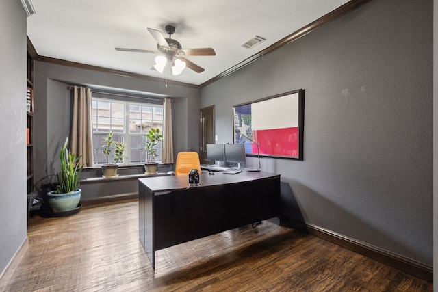 home office with baseboards, crown molding, visible vents, ceiling fan, and wood finished floors