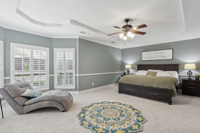 bedroom with baseboards, carpet flooring, crown molding, visible vents, and a tray ceiling