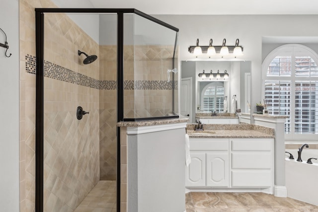 bathroom with a shower stall, vanity, and a garden tub