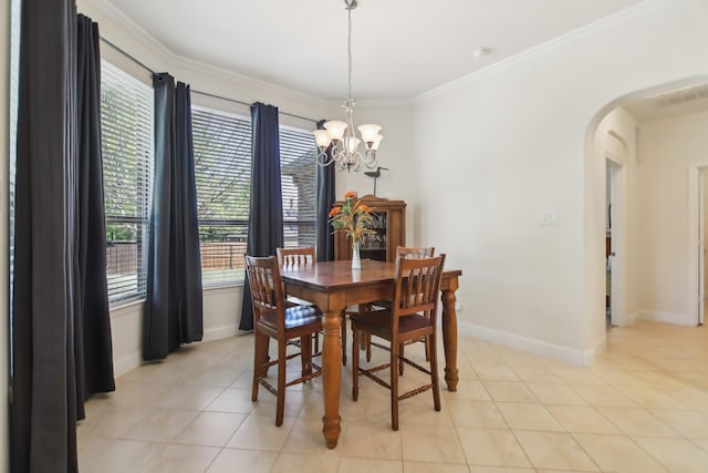 dining room featuring arched walkways, baseboards, an inviting chandelier, crown molding, and light tile patterned floors