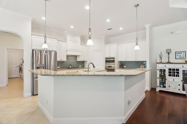 kitchen with backsplash, crown molding, and a sink
