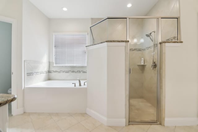 full bath with a garden tub, toilet, tile patterned flooring, and a stall shower