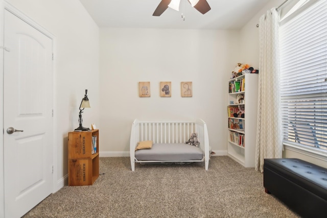 carpeted bedroom with baseboards and ceiling fan