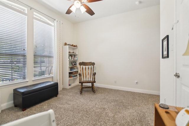 sitting room with baseboards, carpet flooring, and ceiling fan