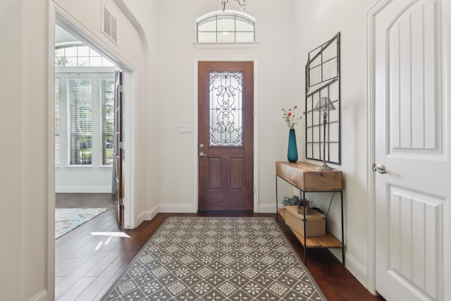 entryway featuring dark wood-style floors, baseboards, and visible vents