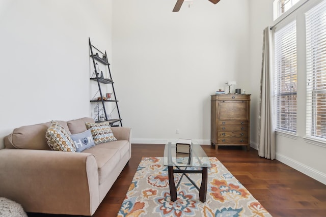 living room with wood finished floors, baseboards, and ceiling fan