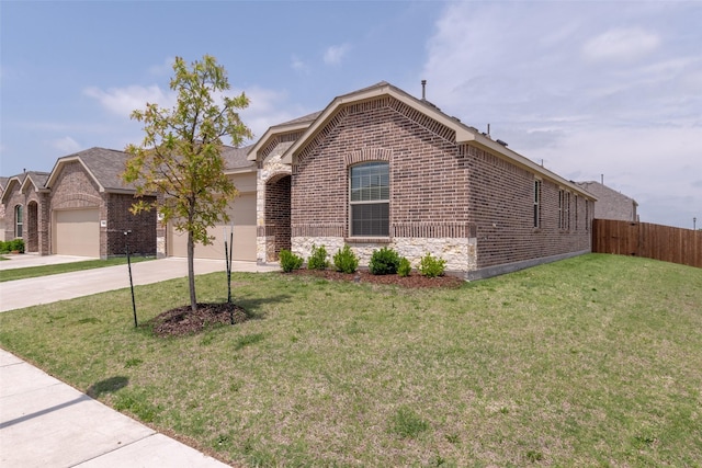 ranch-style house featuring brick siding, fence, driveway, a front lawn, and an attached garage