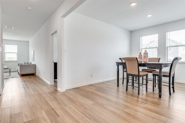 dining room with recessed lighting, visible vents, light wood-style flooring, and baseboards