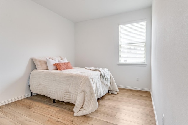 1005 Manuel Dr, Fate, TX 75087 - bedroom featuring baseboards and light wood finished floors
