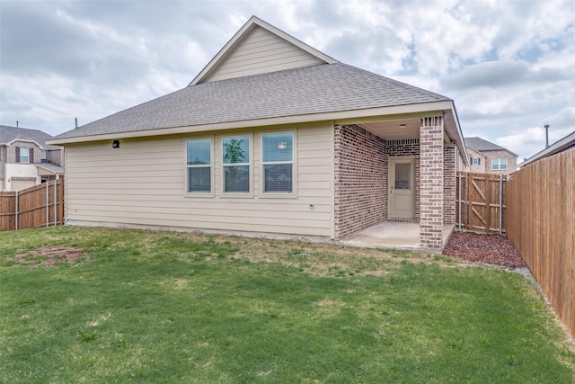 1005 Manuel Dr, Fate, TX 75087 - back of house featuring a fenced backyard, a shingled roof, a patio, and brick siding