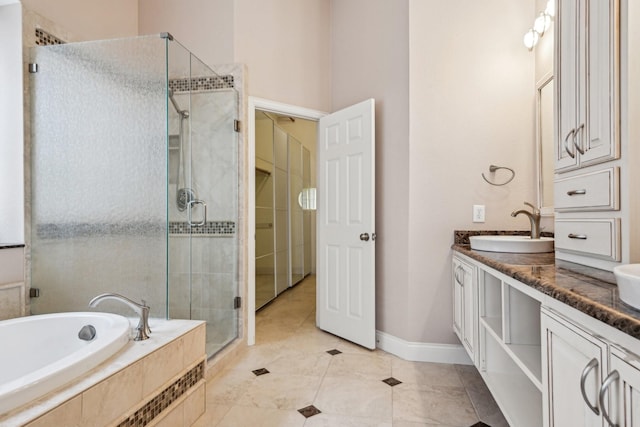 604 Nelson Ct, Plano, TX 75025 - full bath featuring a sink, double vanity, baseboards, a bath, and a stall shower