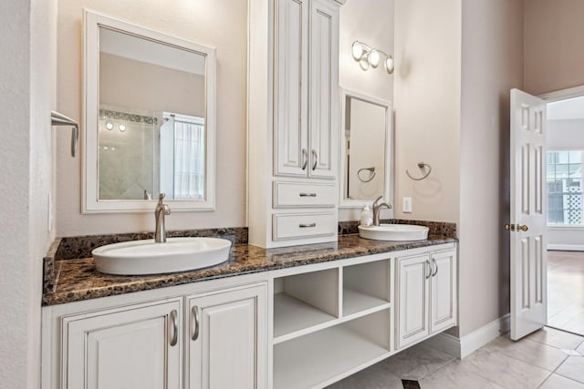 604 Nelson Ct, Plano, TX 75025 - bathroom featuring double vanity, baseboards, and a sink