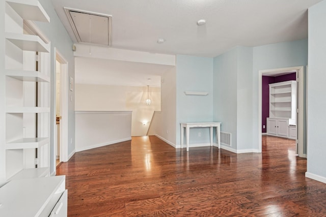 604 Nelson Ct, Plano, TX 75025 - unfurnished living room featuring built in shelves, attic access, wood finished floors, and visible vents