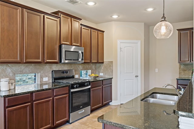 4134 Lee Hutson Dr, Sachse, TX 75048 - kitchen featuring tasteful backsplash, visible vents, dark stone countertops, a sink, and stainless steel appliances
