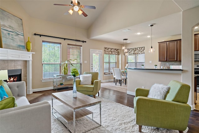 4134 Lee Hutson Dr, Sachse, TX 75048 - living area featuring dark wood-type flooring, ceiling fan, a wealth of natural light, and a tile fireplace