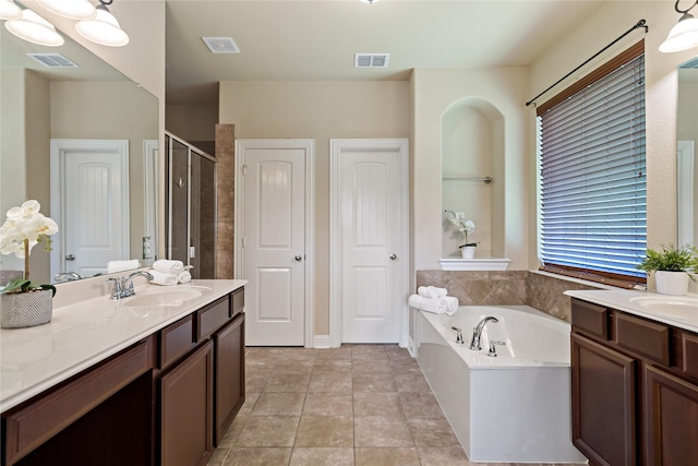 4134 Lee Hutson Dr, Sachse, TX 75048 - bathroom with two vanities, a sink, a stall shower, visible vents, and a garden tub