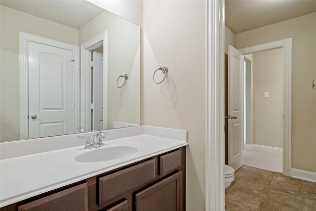 4134 Lee Hutson Dr, Sachse, TX 75048 - bathroom with tile patterned floors, toilet, vanity, and baseboards