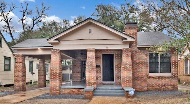 bungalow with brick siding and a chimney