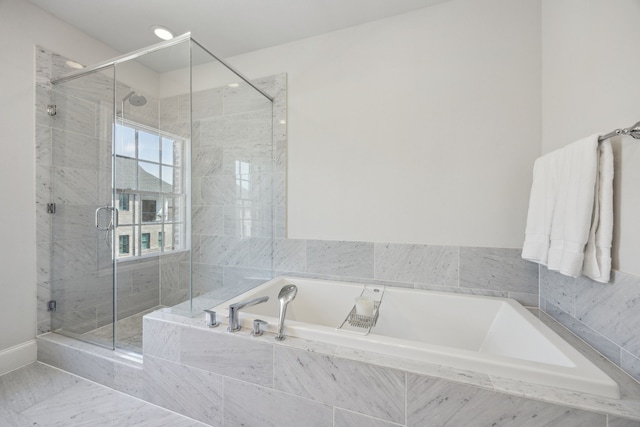 full bath featuring a shower stall and a bath