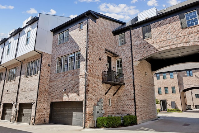 view of building exterior with an attached garage and driveway