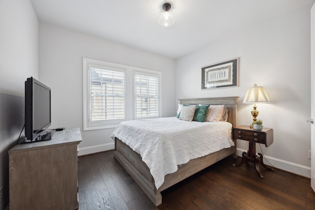 bedroom with baseboards and dark wood-style floors