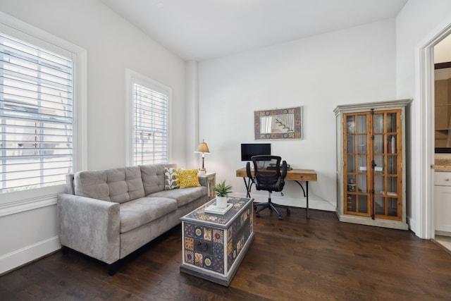 living area with baseboards and wood finished floors