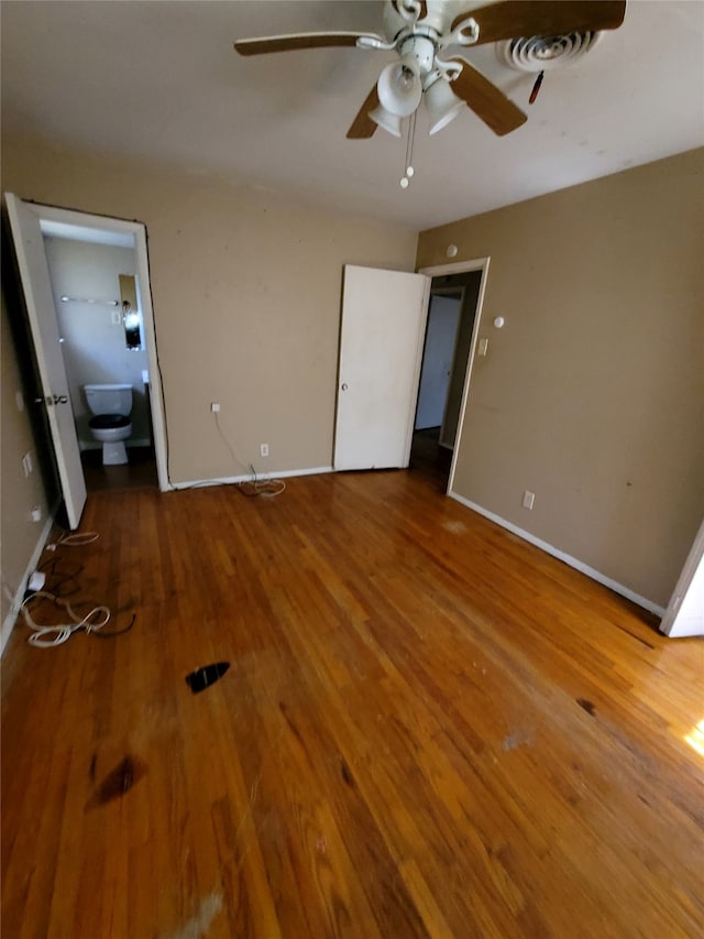 unfurnished bedroom with baseboards and wood finished floors