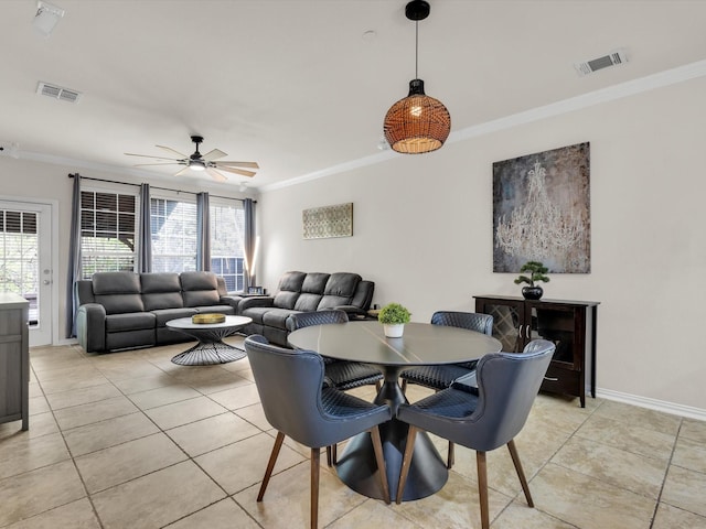 dining space featuring crown molding and visible vents